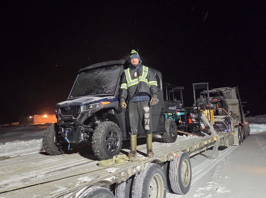 Customer with a CFMOTO side-by-side on a flatbed at night