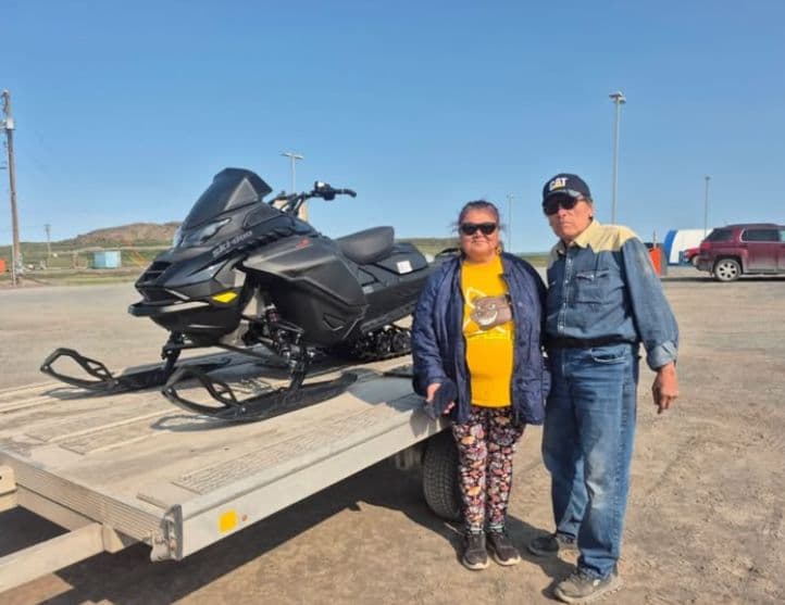 Two customers with a Ski-Doo on a trailer